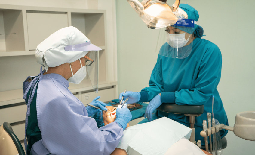 Periodoncista atendiendo a paciente con enfermedad periodontal
